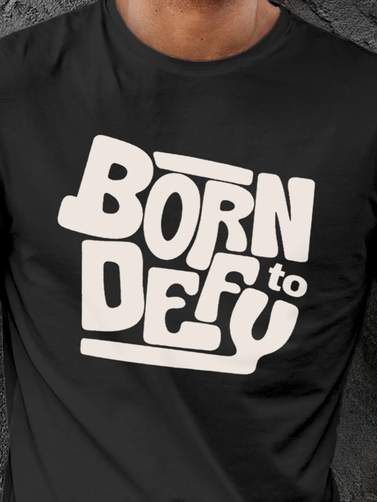 Close up of 'Born To Defy' design on Men's Dark Grey Round Neck T-shirt, highlighting intricate details and vibrant print.