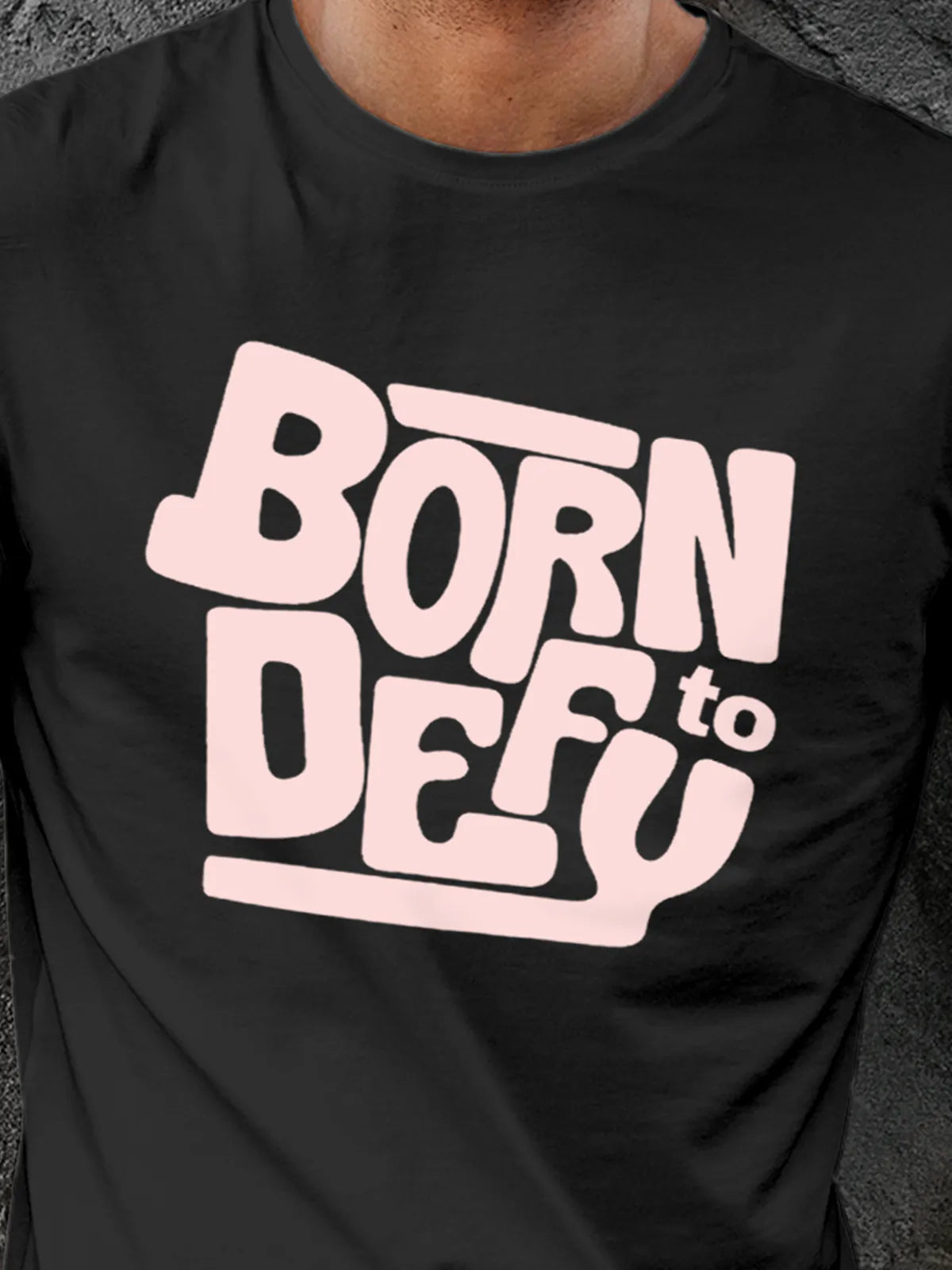Close up of 'Born To Defy' design on Men's Dark Grey Round Neck T-shirt, highlighting intricate details and vibrant print.