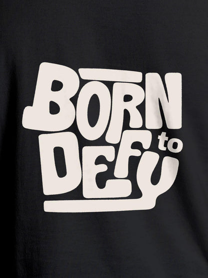 Close up of 'Born To Defy' design on Women's Dark Grey Round Neck T-shirt, highlighting intricate details and vibrant print.