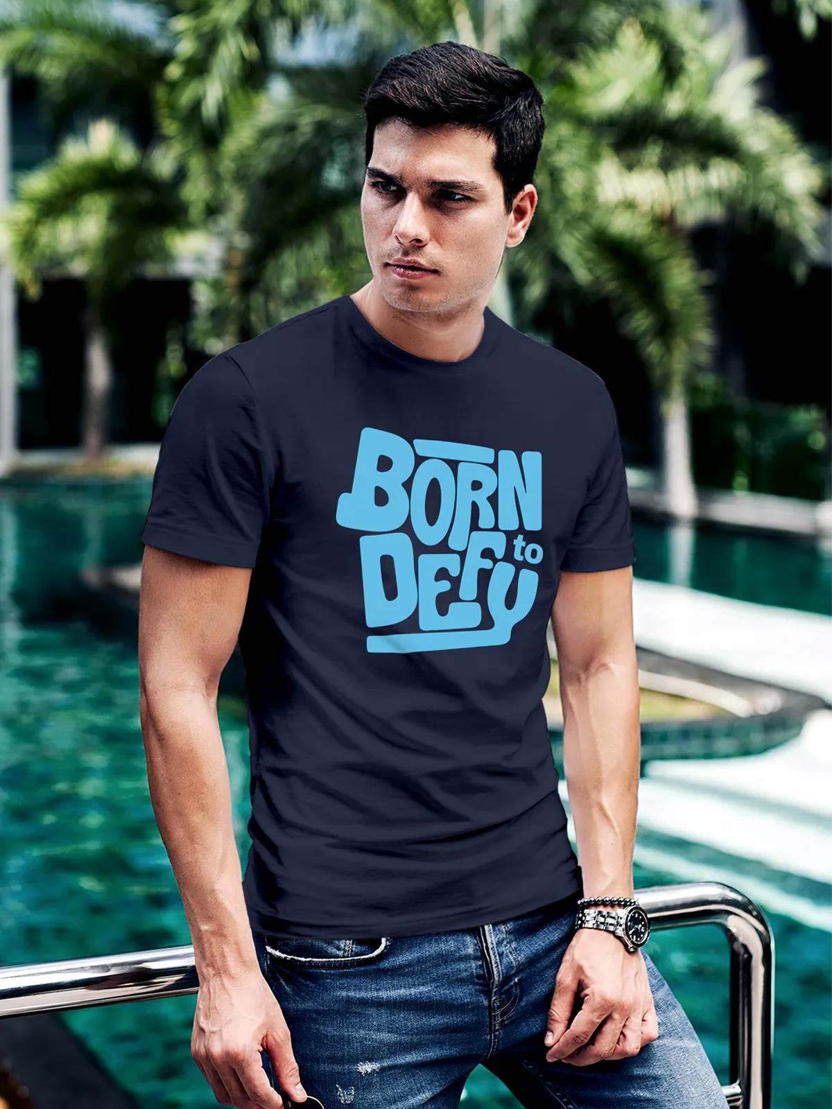 Model wearing Men's Navy Blue Round Neck T-shirt with 'Born To Defy' design, offering effortless style and premium comfort