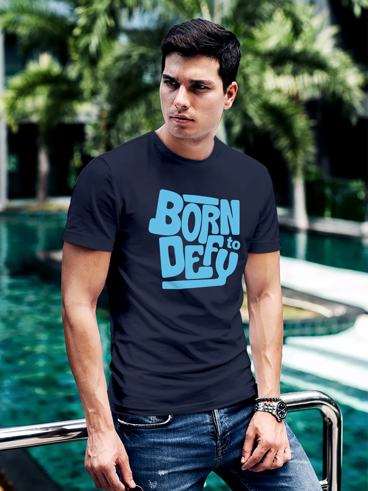 Model wearing Men's Navy Blue Round Neck T-shirt with 'Born To Defy' design, offering effortless style and premium comfort