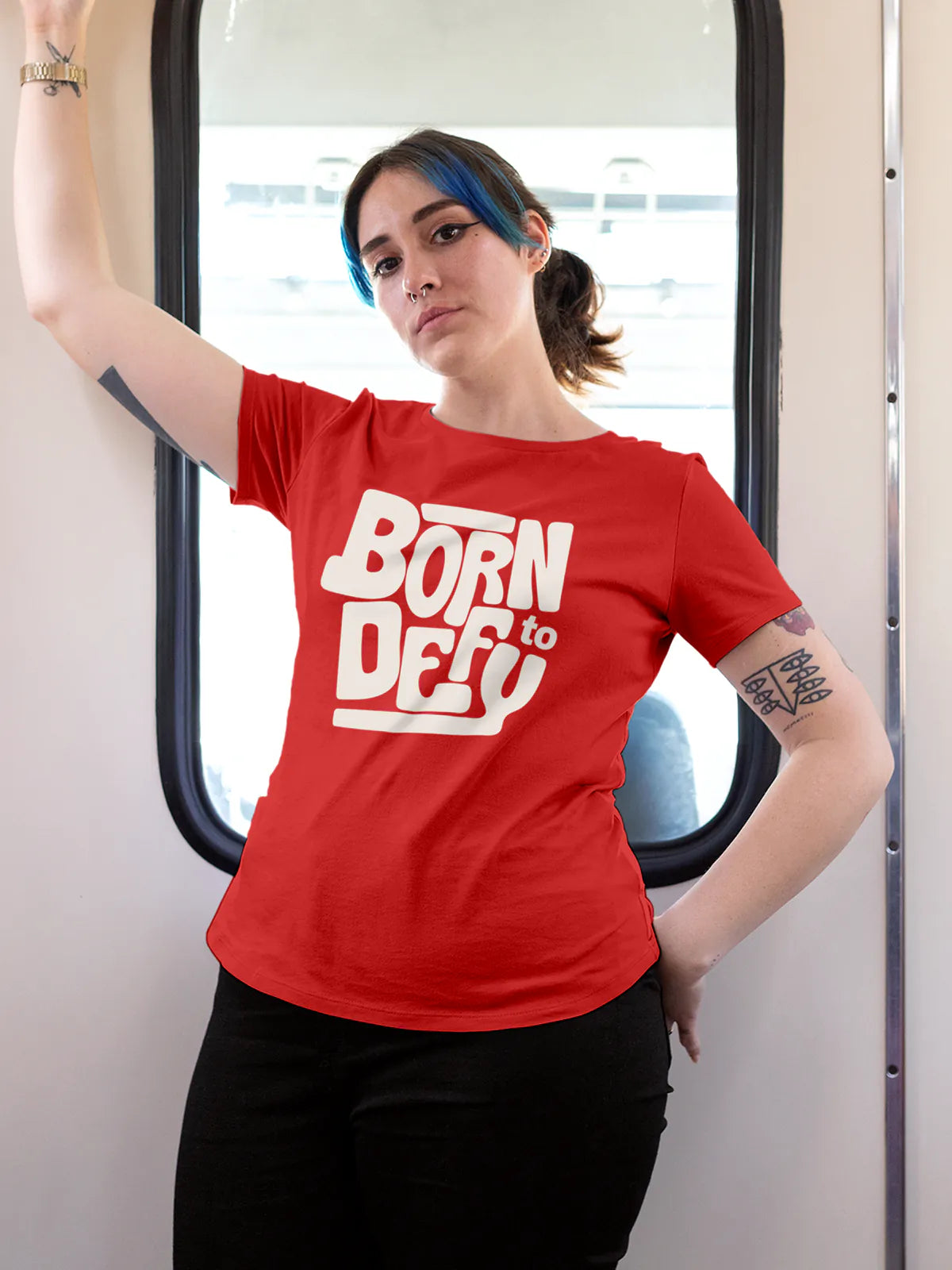 Model wearing Women's Red Round Neck T-shirt with 'Born To Defy' design, offering effortless style and premium comfort