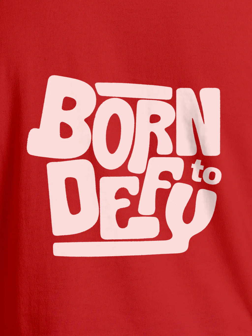 Close up of 'Born To Defy' design on Women's Red Round Neck T-shirt, highlighting intricate details and vibrant print.