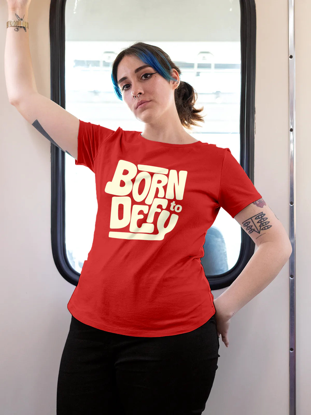 Model wearing Women's Red Round Neck T-shirt with 'Born To Defy' design, offering effortless style and premium comfort