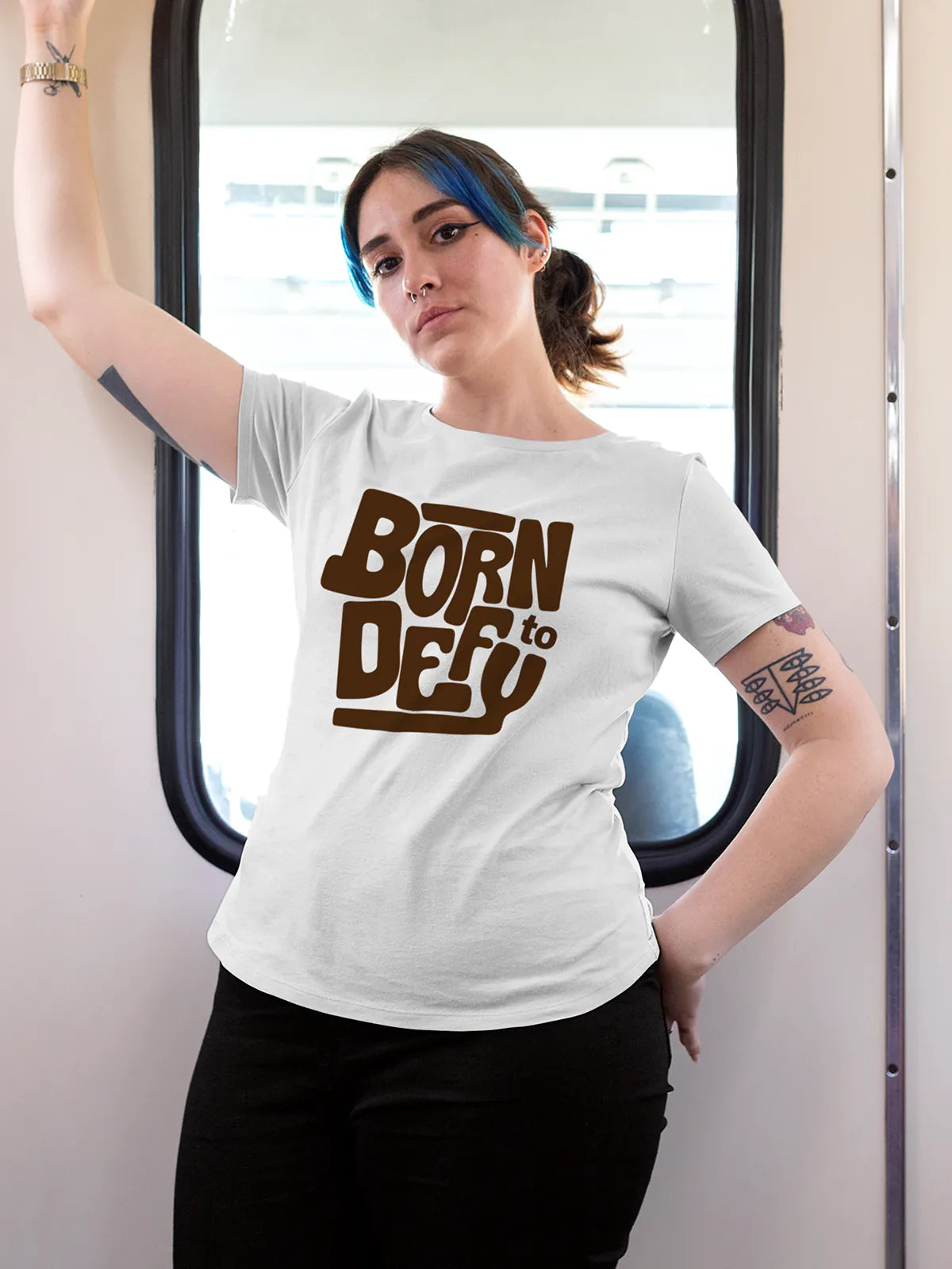 Model wearing Women's White Round Neck T-shirt with 'Born To Defy' design, offering effortless style and premium comfort