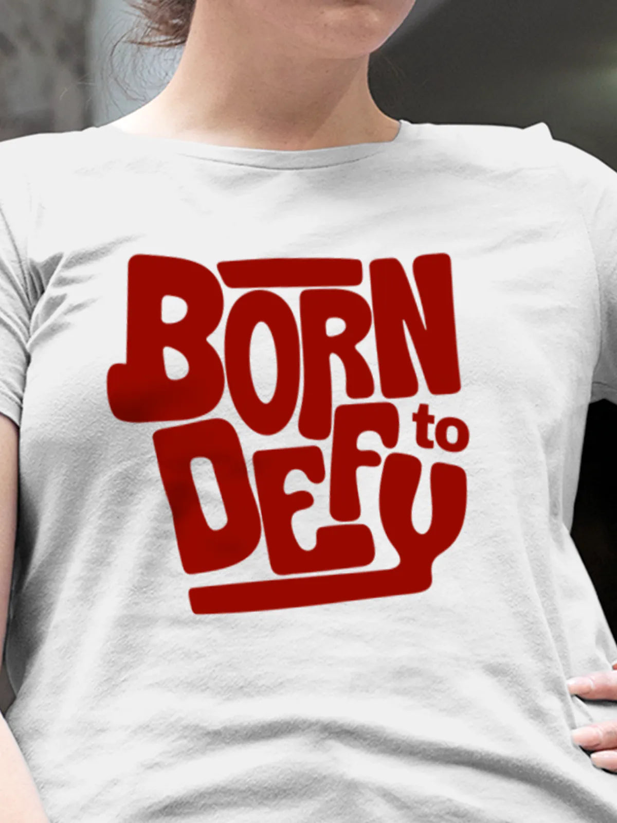 Close up of 'Born To Defy' design on Women's White Round Neck T-shirt, highlighting intricate details and vibrant print.