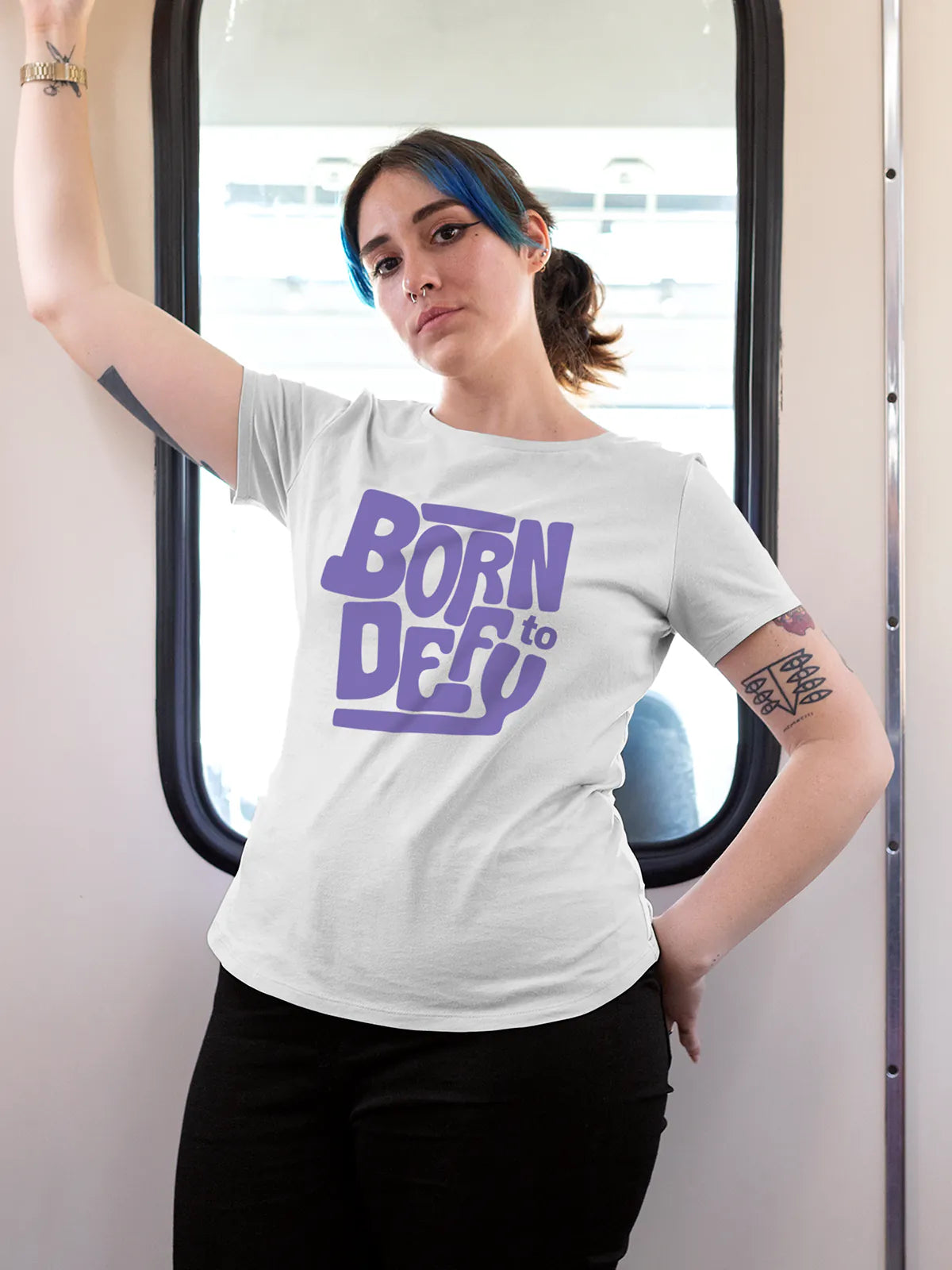 Model wearing Women's White Round Neck T-shirt with 'Born To Defy' design, offering effortless style and premium comfort
