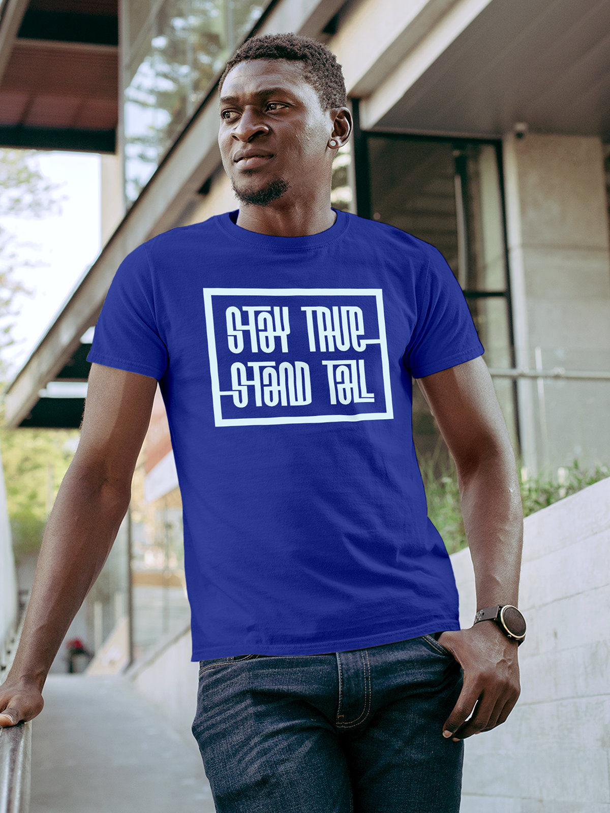 Model wearing Men's Blue Round Neck T-shirt with 'Stay True Stand Tall' design, offering effortless style and premium comfort