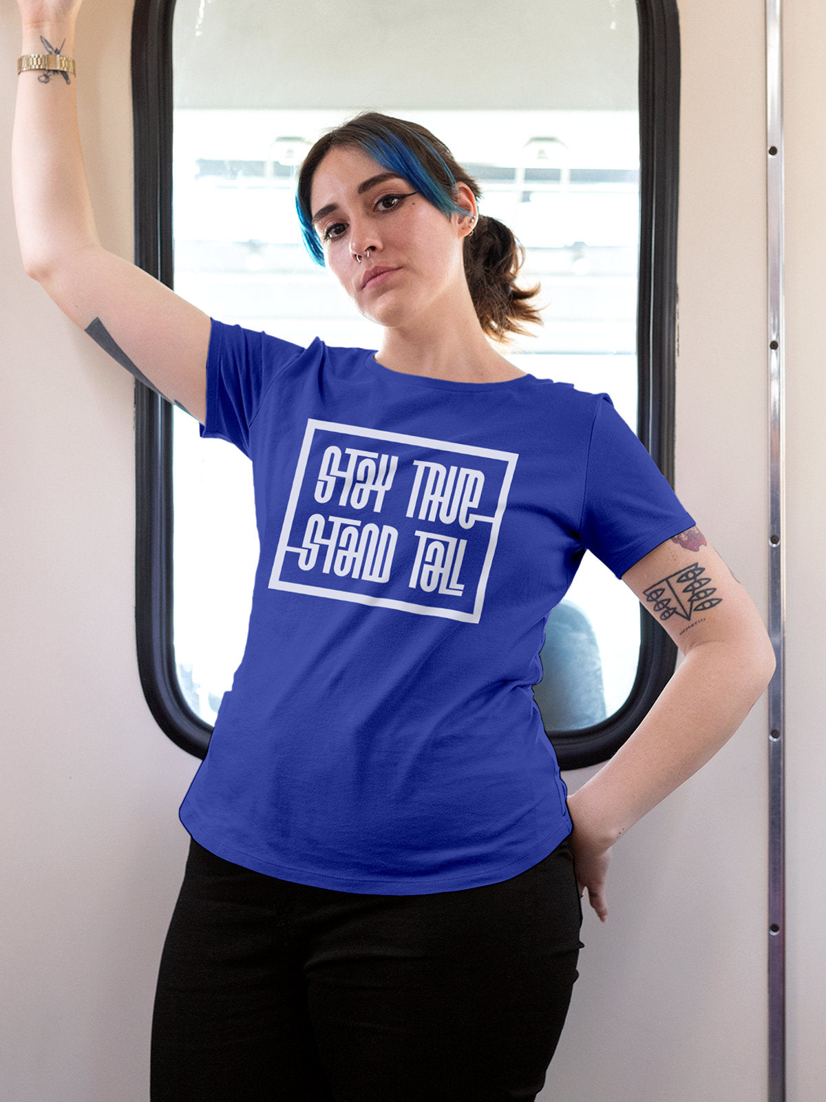 Model wearing Women's Blue Round Neck T-shirt with 'Stay True Stand Tall' design, offering effortless style and premium comfort