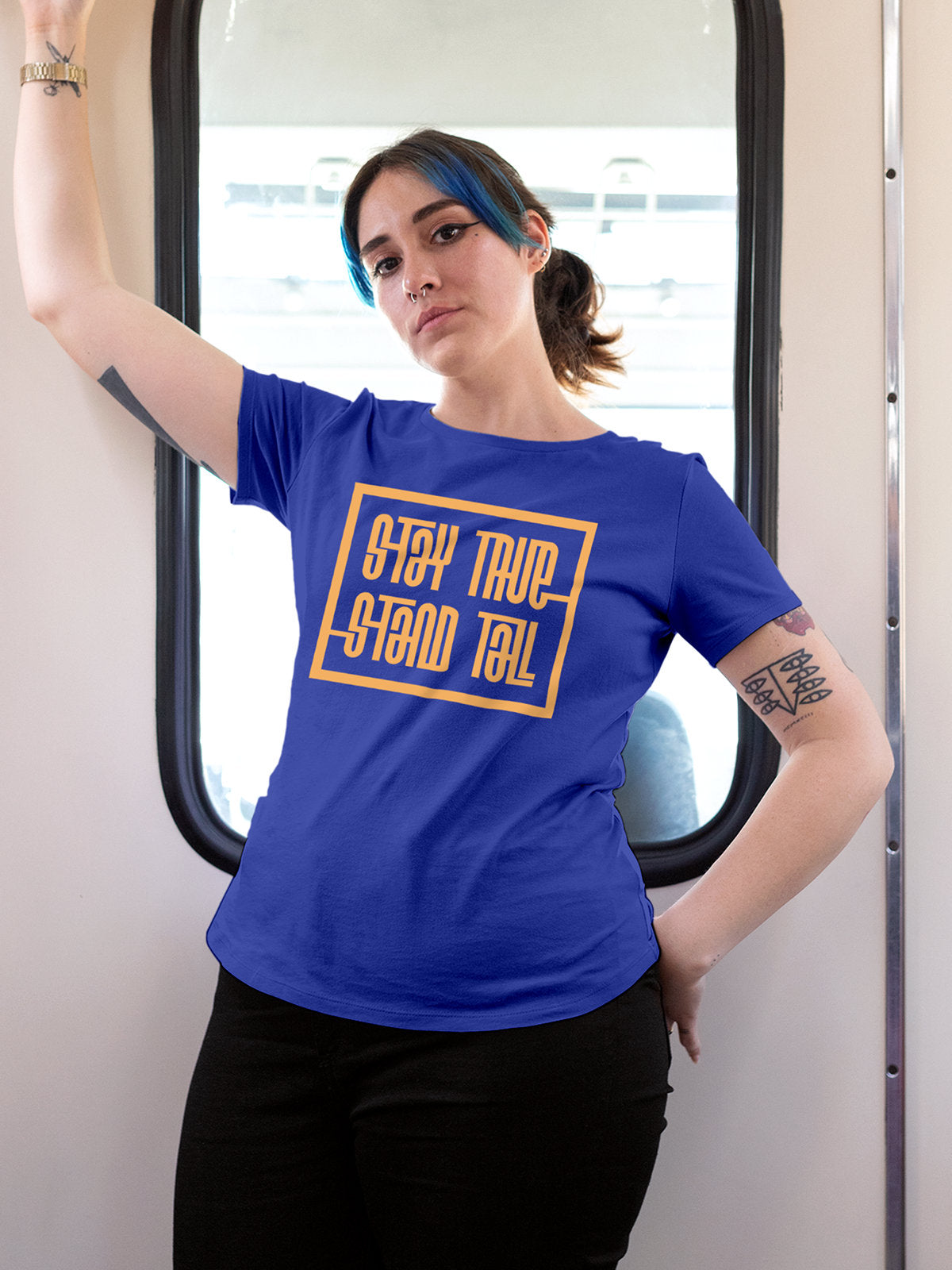 Model wearing Women's Blue Round Neck T-shirt with 'Stay True Stand Tall' design, offering effortless style and premium comfort
