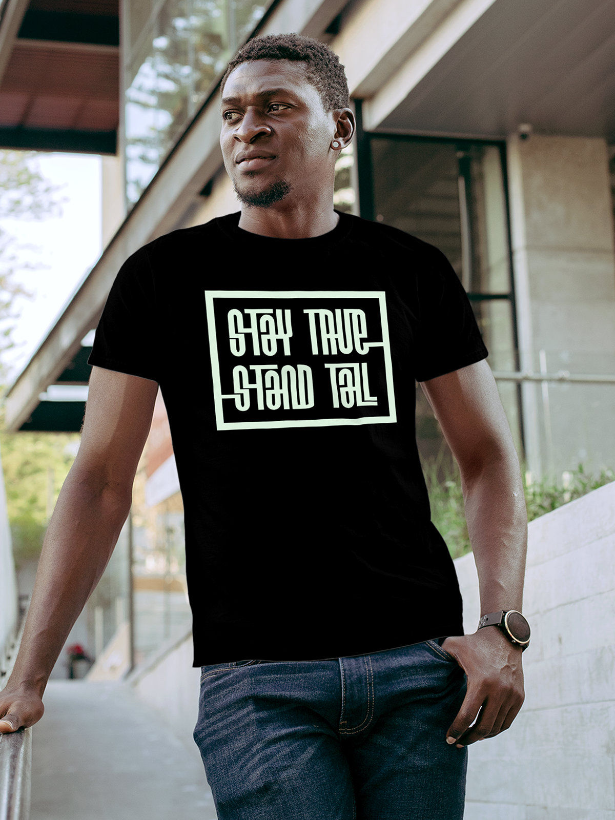 Model wearing Men's Black Round Neck T-shirt with 'Stay True Stand Tall' design, offering effortless style and premium comfort