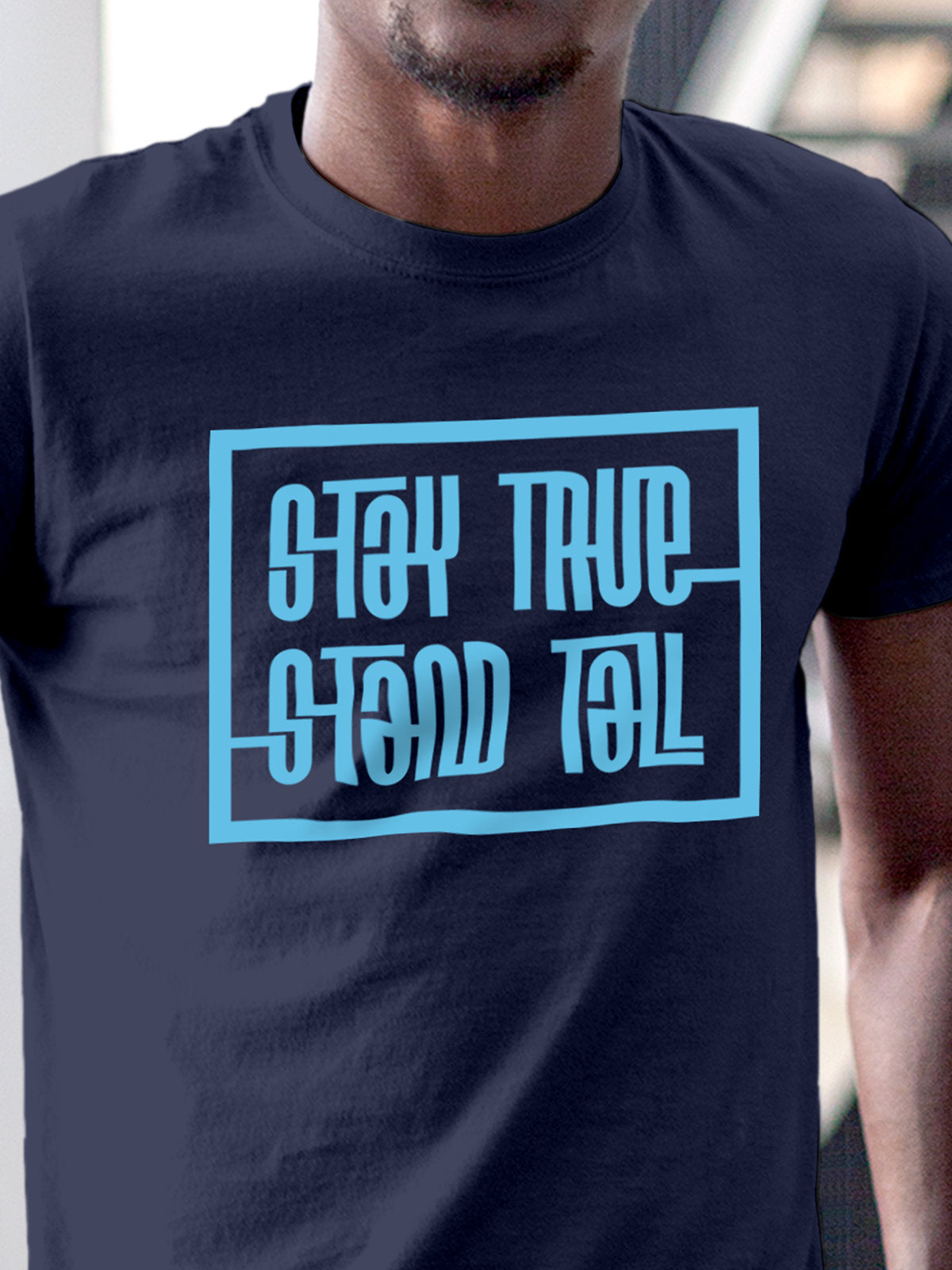 Close up of 'Stay True Stand Tall' design on Men's Navy Blue Round Neck T-shirt, highlighting intricate details and vibrant print.