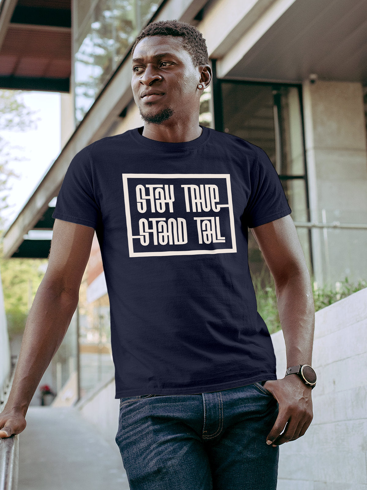 Model wearing Men's Navy Blue Round Neck T-shirt with 'Stay True Stand Tall' design, offering effortless style and premium comfort