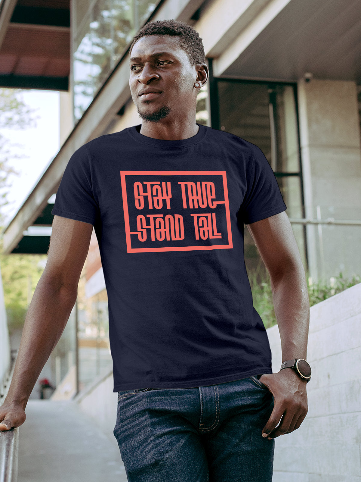 Model wearing Men's Navy Blue Round Neck T-shirt with 'Stay True Stand Tall' design, offering effortless style and premium comfort