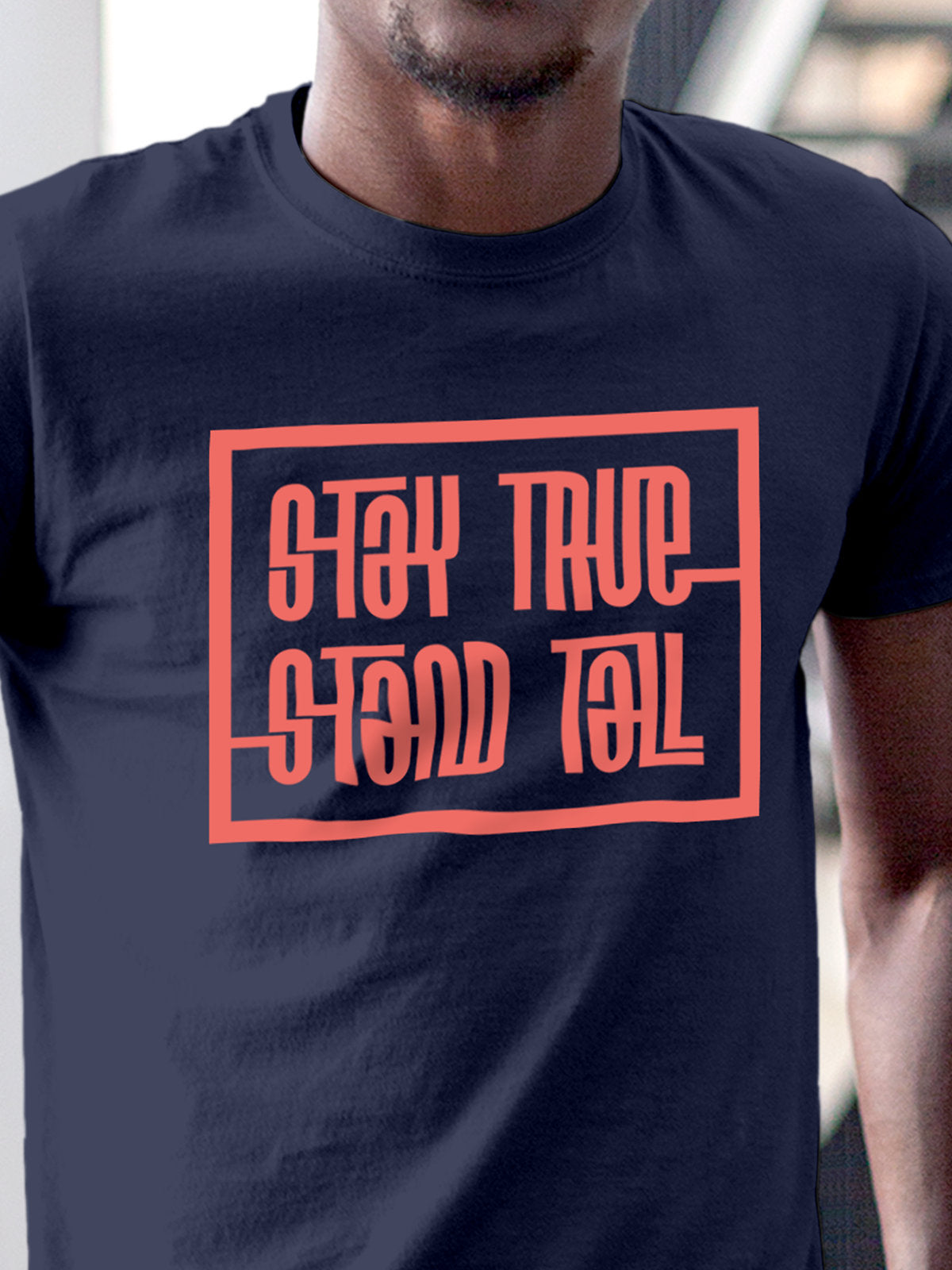 Close up of 'Stay True Stand Tall' design on Men's Navy Blue Round Neck T-shirt, highlighting intricate details and vibrant print.