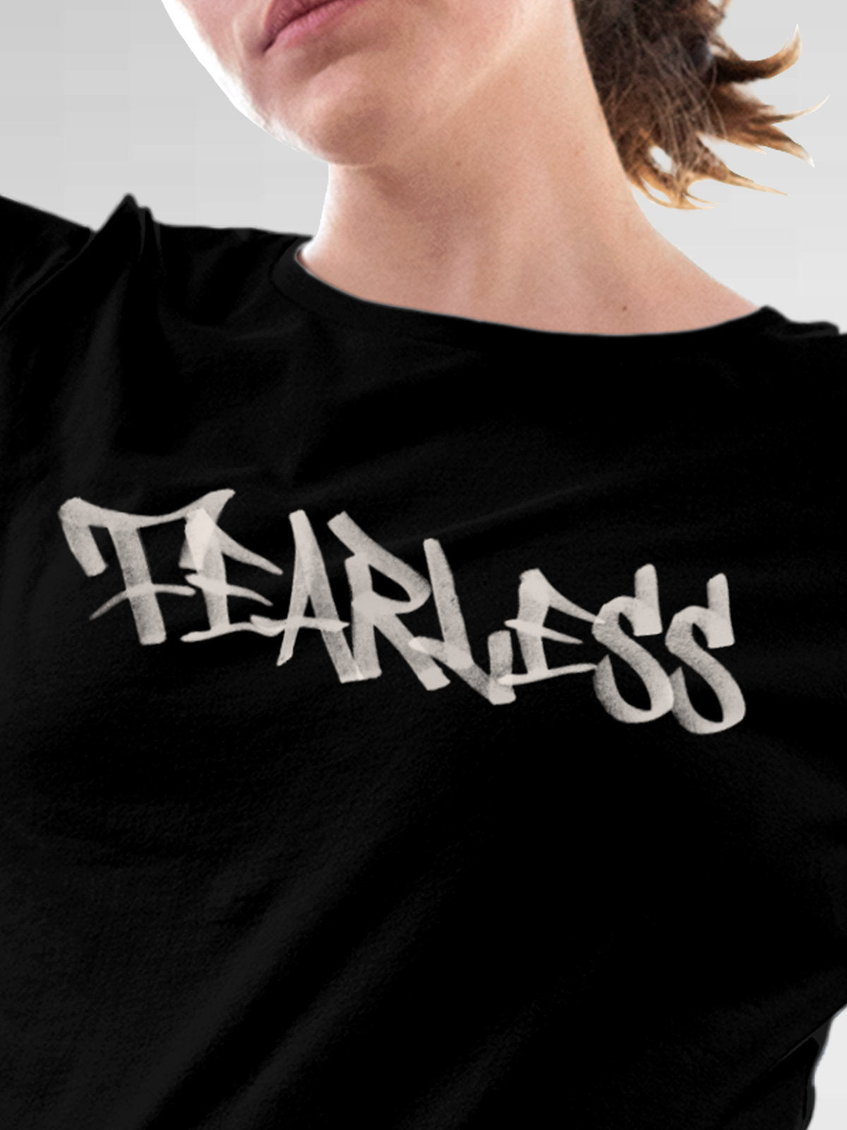 Close up of 'Fearless' design on Women's Black Round Neck T-shirt, highlighting intricate details and vibrant print.