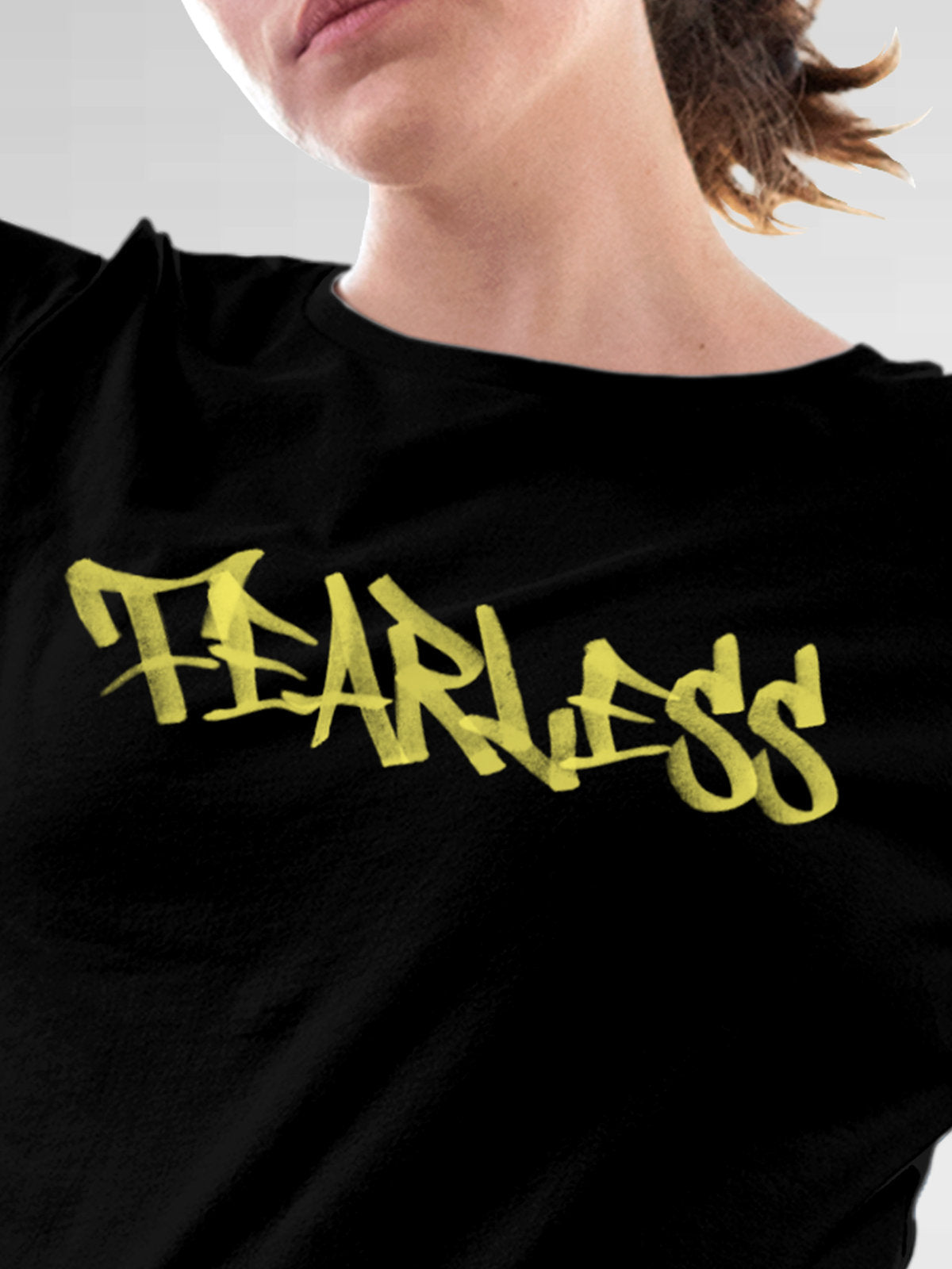 Close up of 'Fearless' design on Women's Black Round Neck T-shirt, highlighting intricate details and vibrant print.