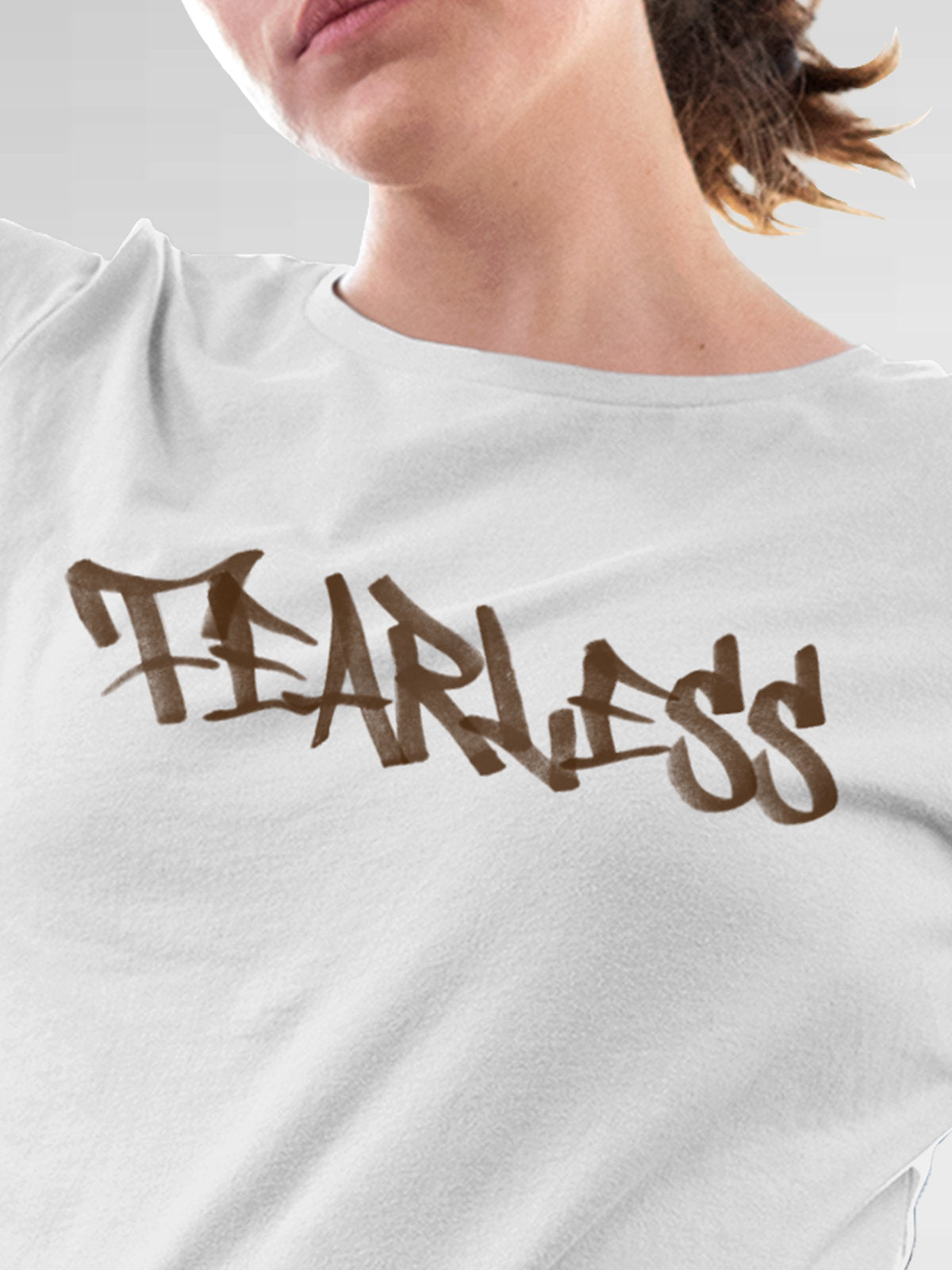 Close up of 'Fearless' design on Women's White Round Neck T-shirt, highlighting intricate details and vibrant print.