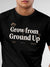 Close up of 'Grow From Ground Up' design on Men's Black Round Neck T-shirt, highlighting intricate details and vibrant print.