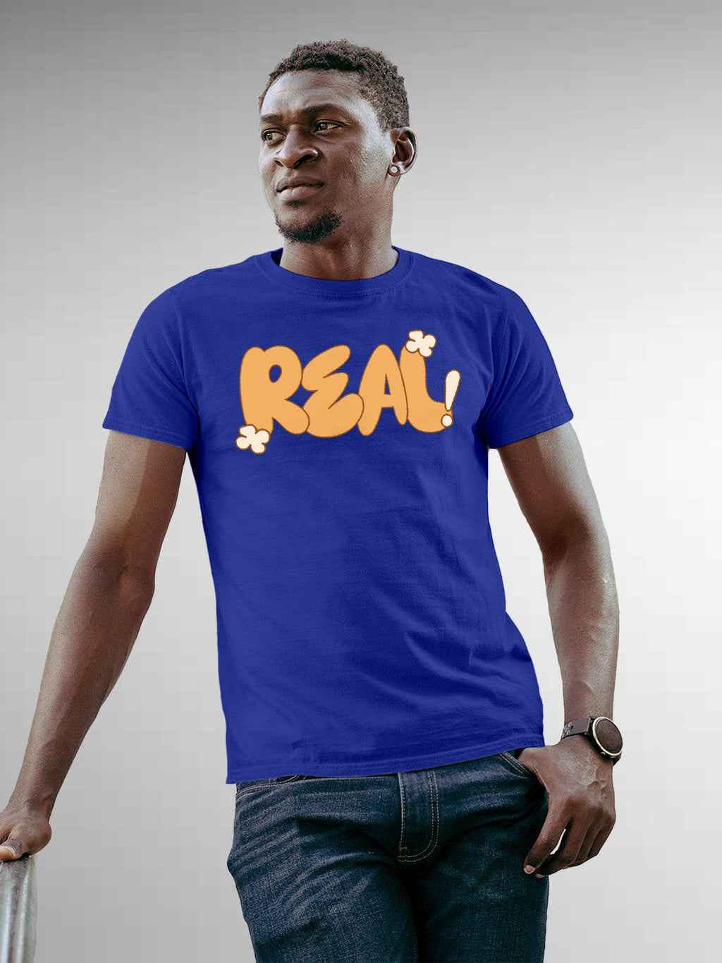 Model wearing Men's Blue Round Neck T-shirt with 'Real' design, offering effortless style and premium comfort