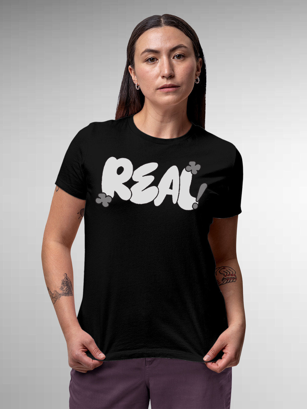 Model wearing Women's Black Round Neck T-shirt with 'Real' design, offering effortless style and premium comfort