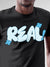 Close up of 'Real' design on Men's Dark Grey Round Neck T-shirt, highlighting intricate details and vibrant print.