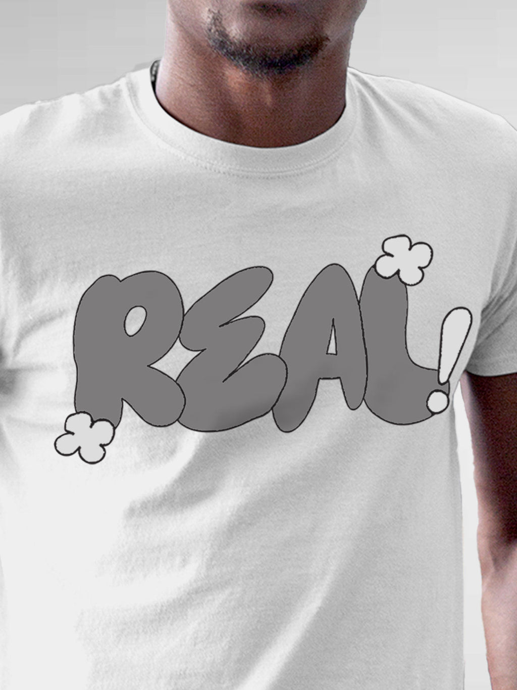 Close up of 'Real' design on Men's White Round Neck T-shirt, highlighting intricate details and vibrant print.