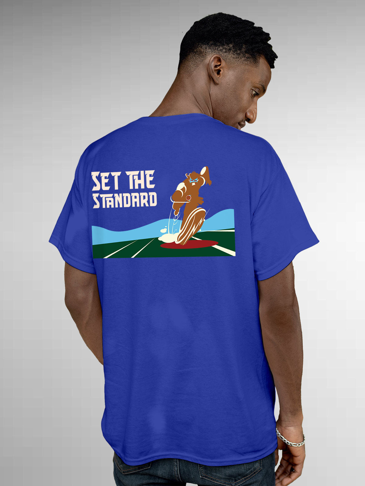 Model wearing Men's Blue Round Neck T-shirt with 'Set The Standard' design, offering effortless style and premium comfort