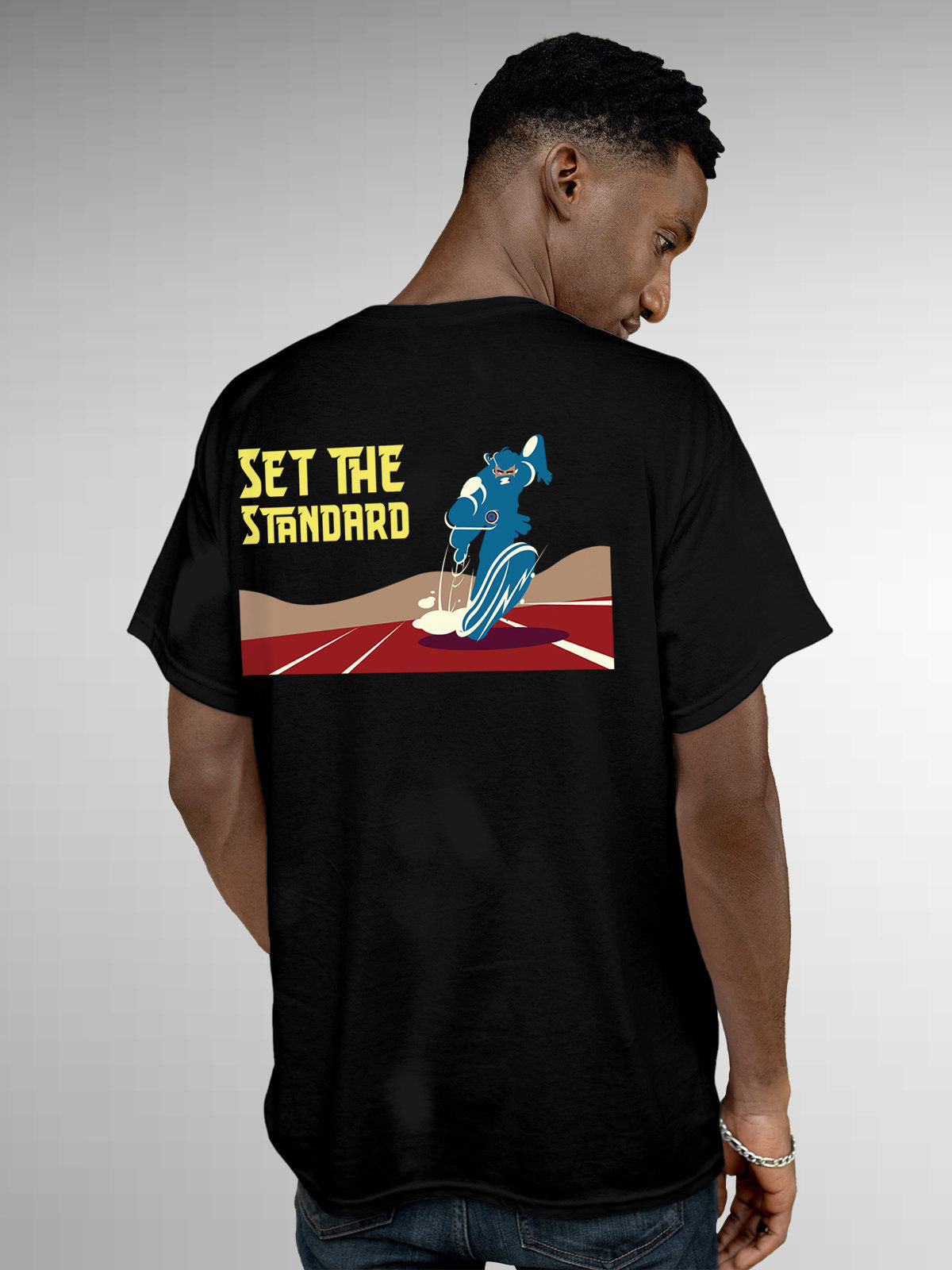 Model wearing Men's Black Round Neck T-shirt with 'Set The Standard' design, offering effortless style and premium comfort