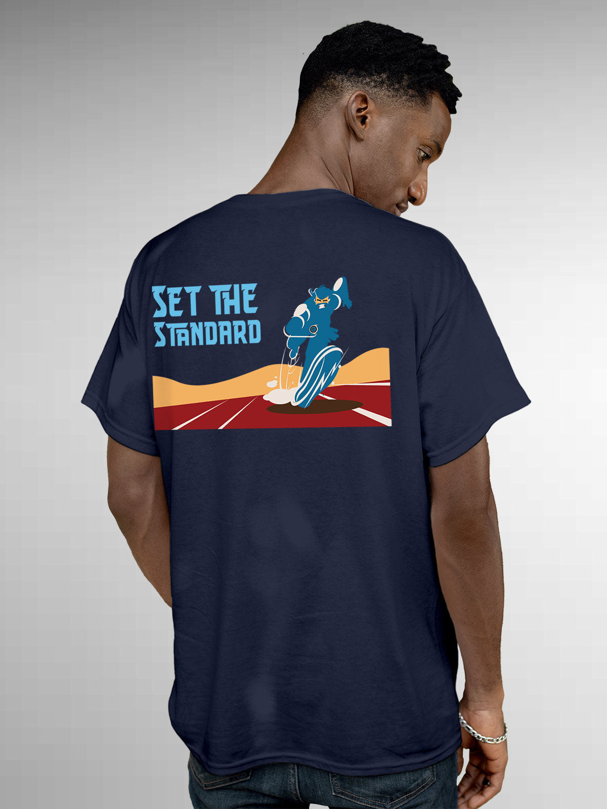 Model wearing Men's Navy Blue Round Neck T-shirt with 'Set The Standard' design, offering effortless style and premium comfort