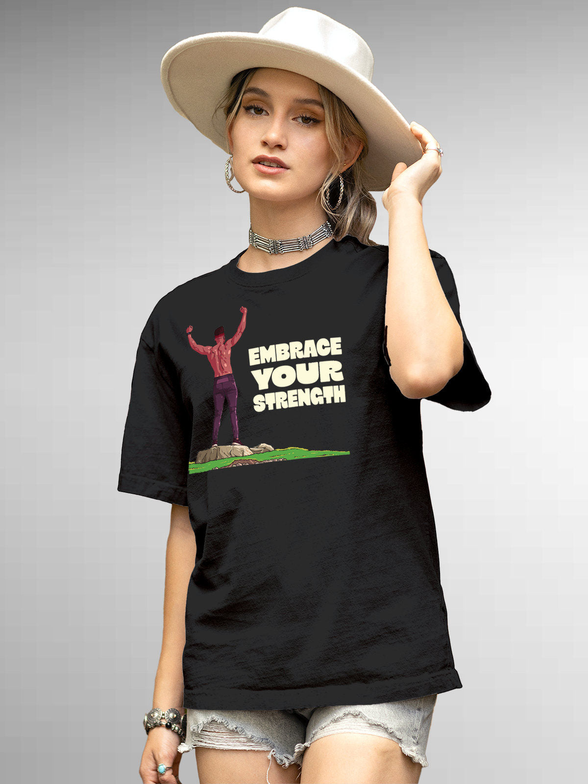 Model wearing Women's Dark Grey Round Neck T-shirt with 'Embrace Your Strength' design, offering effortless style and premium comfort