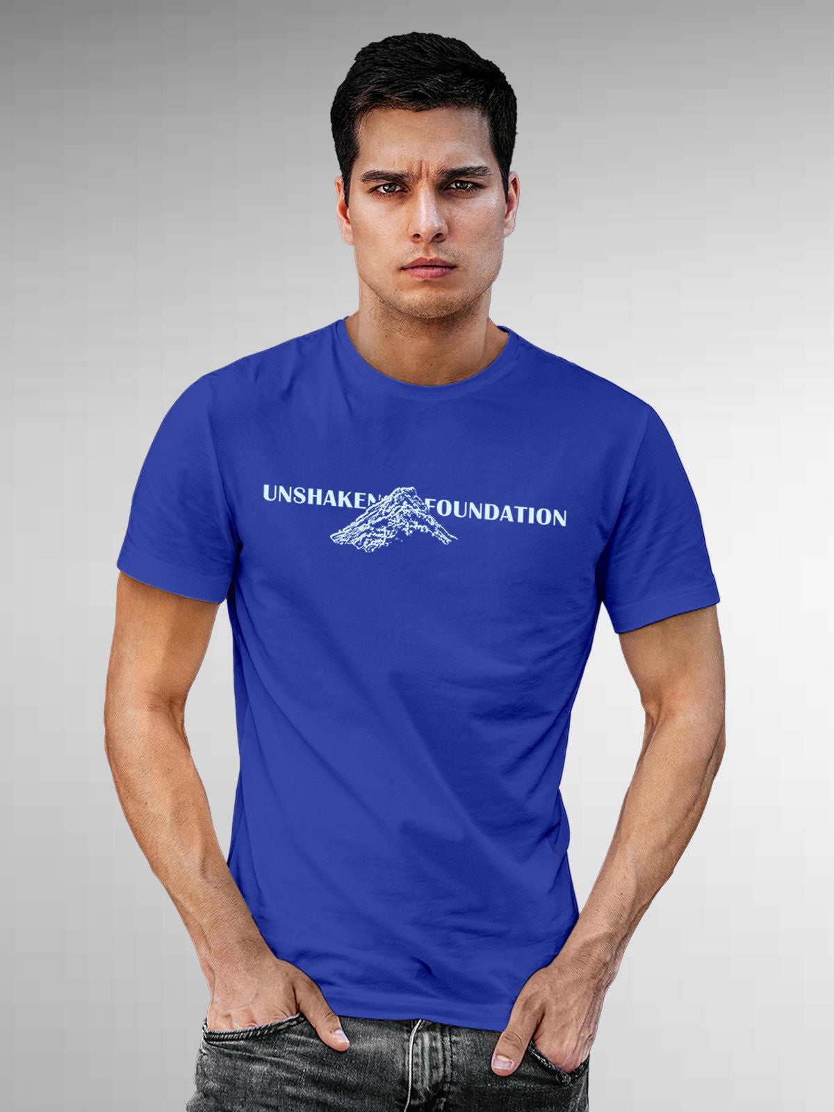 Model wearing Men's Blue Round Neck T-shirt with 'Unshaken Foundation' design, offering effortless style and premium comfort