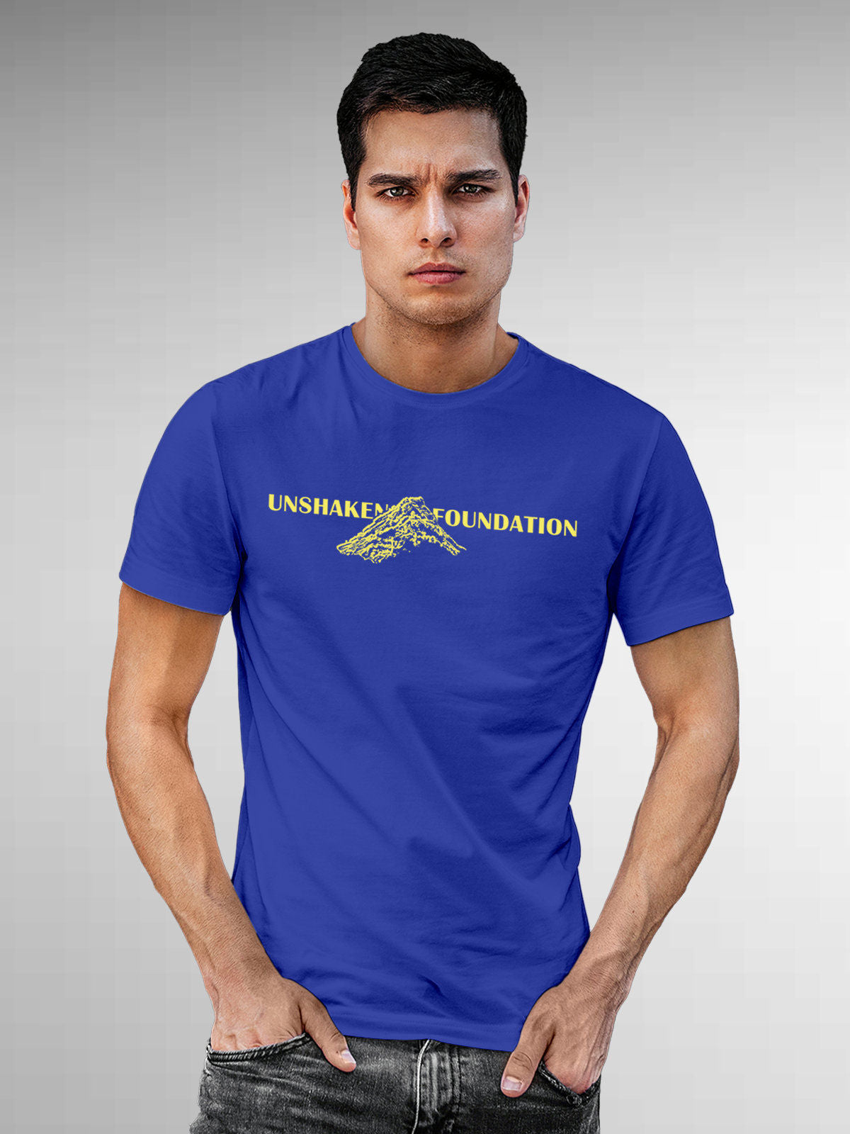 Model wearing Men's Blue Round Neck T-shirt with 'Unshaken Foundation' design, offering effortless style and premium comfort