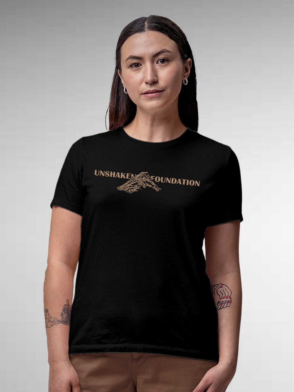 Model wearing Women's Black Round Neck T-shirt with 'Unshaken Foundation' design, offering effortless style and premium comfort