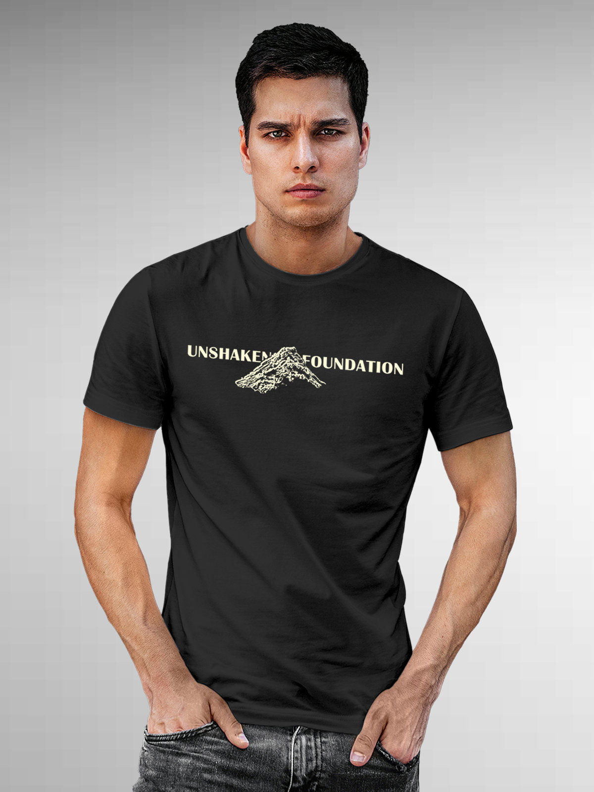 Model wearing Men's Dark Grey Round Neck T-shirt with 'Unshaken Foundation' design, offering effortless style and premium comfort