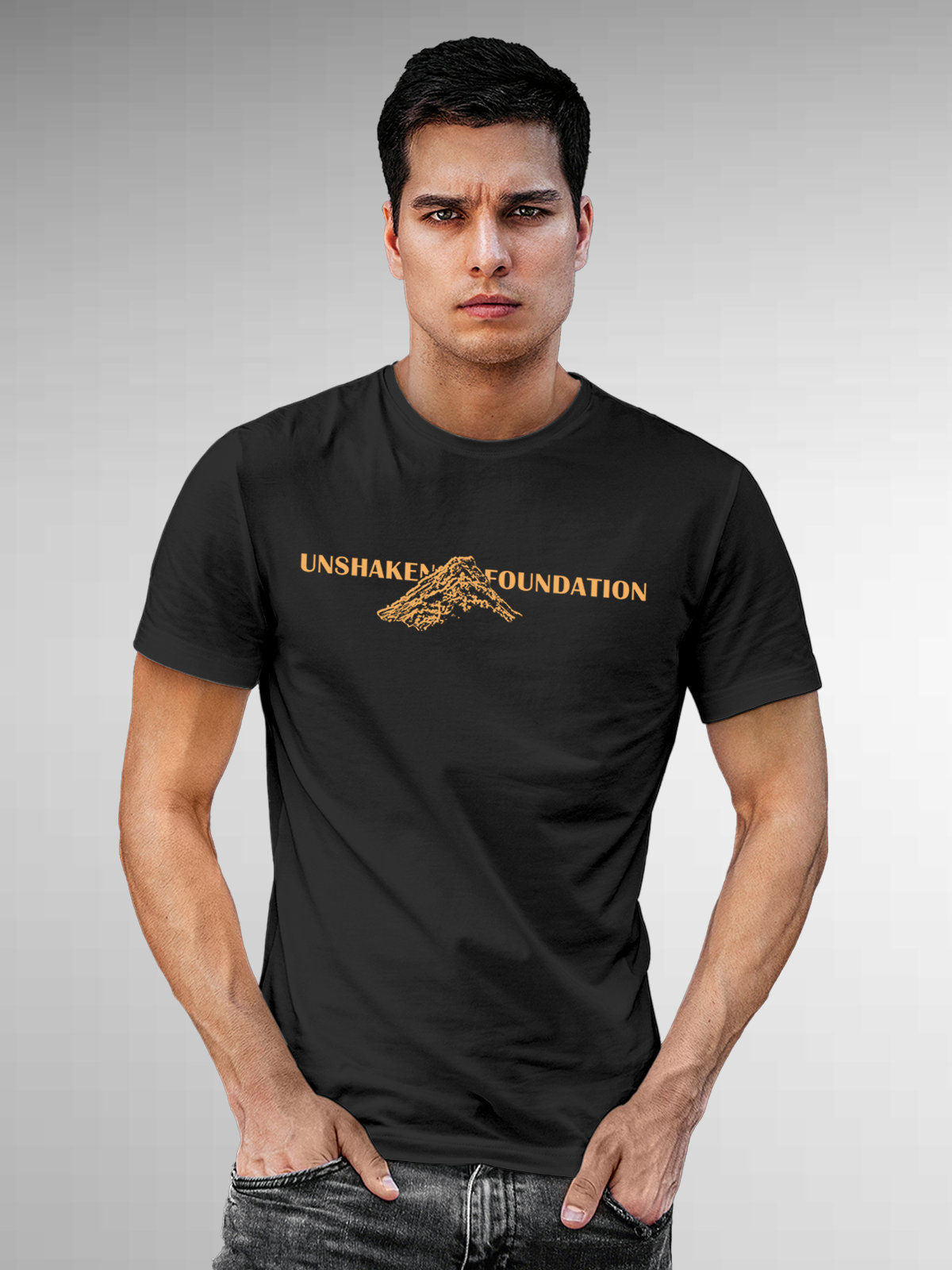 Model wearing Men's Dark Grey Round Neck T-shirt with 'Unshaken Foundation' design, offering effortless style and premium comfort