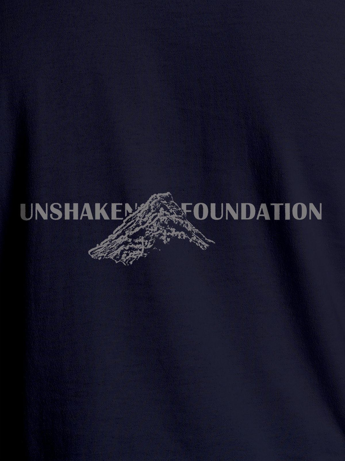 Close up of 'Unshaken Foundation' design on Men's Navy Blue Round Neck T-shirt, highlighting intricate details and vibrant print.