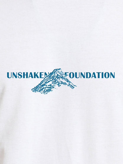 Close up of 'Unshaken Foundation' design on Women's White Round Neck T-shirt, highlighting intricate details and vibrant print.