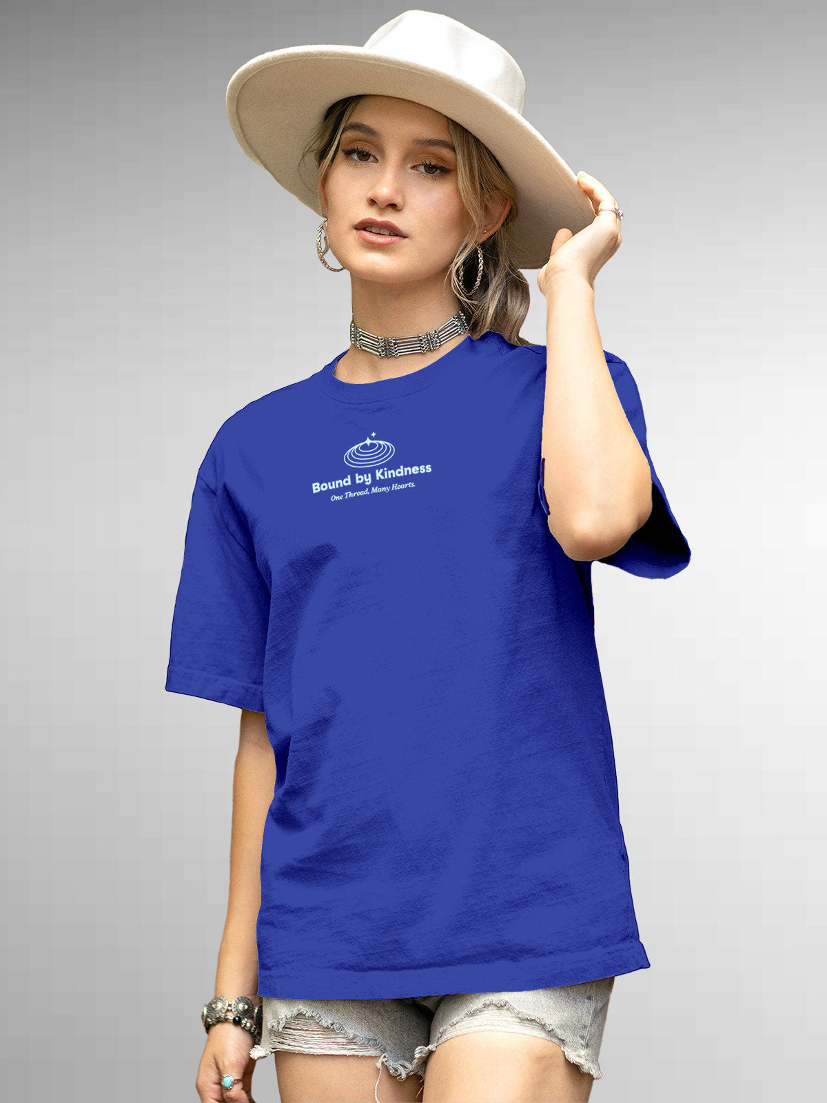 Model wearing Women's Blue Round Neck T-shirt with 'Bound By Kindness' design, offering effortless style and premium comfort