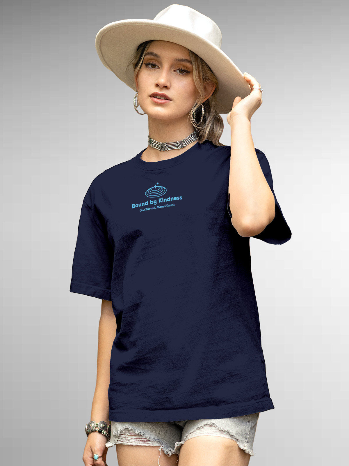 Model wearing Women's Navy Blue Round Neck T-shirt with 'Bound By Kindness' design, offering effortless style and premium comfort