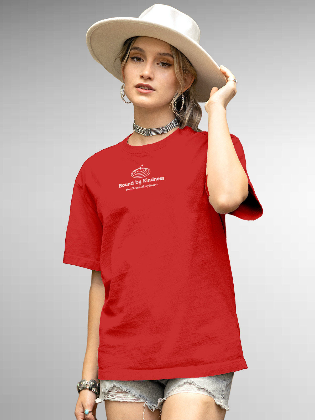 Model wearing Women's Red Round Neck T-shirt with 'Bound By Kindness' design, offering effortless style and premium comfort