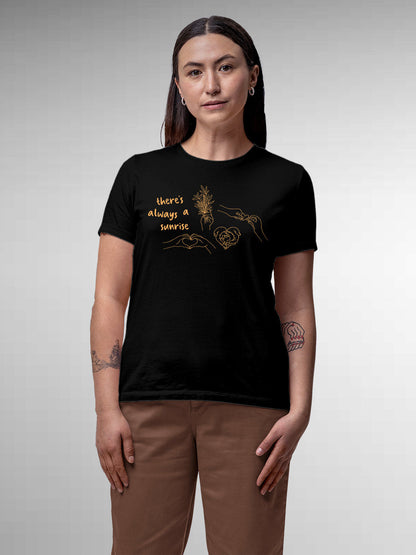 Model wearing Women's Black Round Neck T-shirt with 'There's Always a Sunrise' design, offering effortless style and premium comfort
