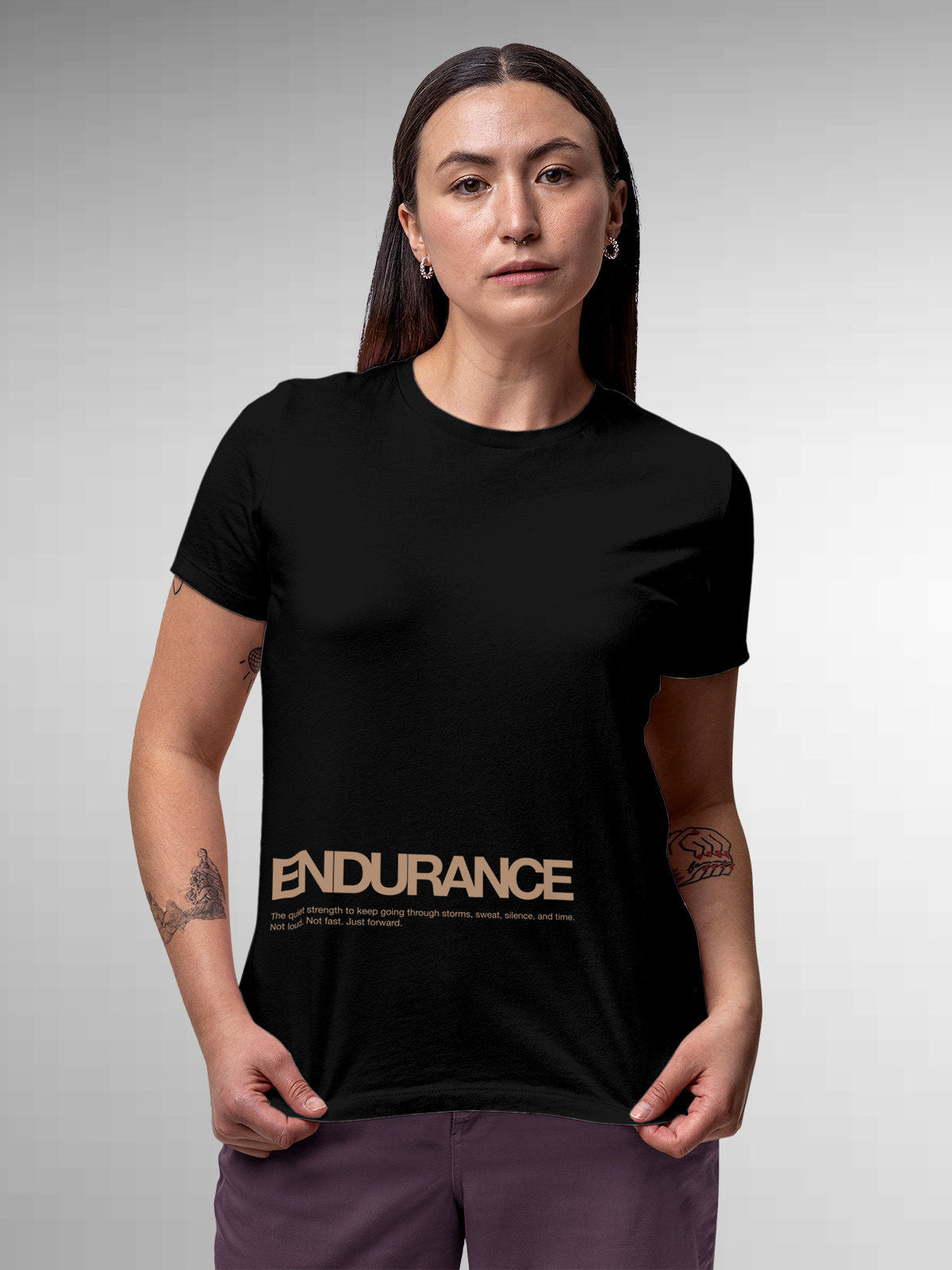 Model wearing Women's Black Round Neck T-shirt with 'Endurance' design, offering effortless style and premium comfort