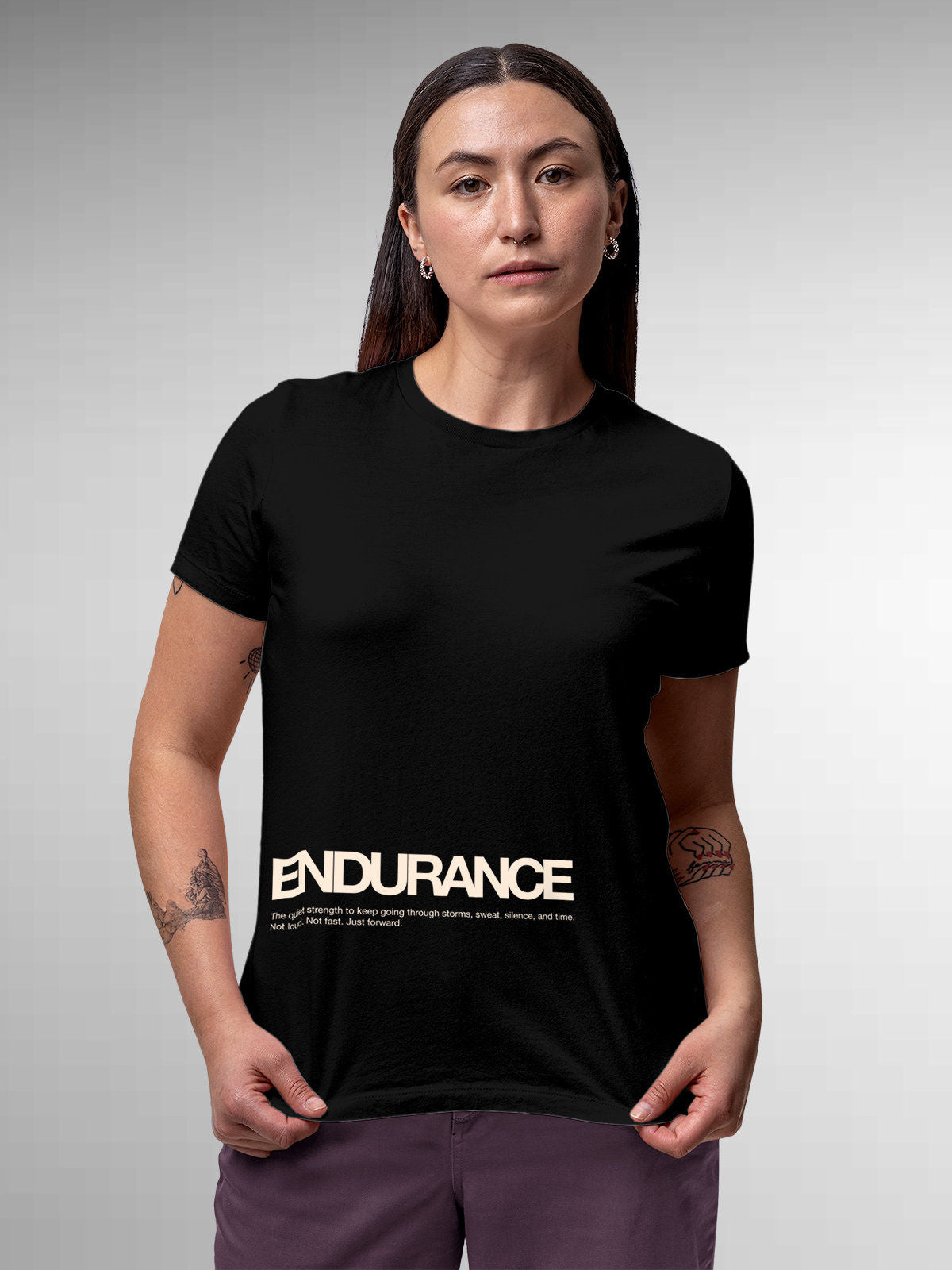 Model wearing Women's Black Round Neck T-shirt with 'Endurance' design, offering effortless style and premium comfort
