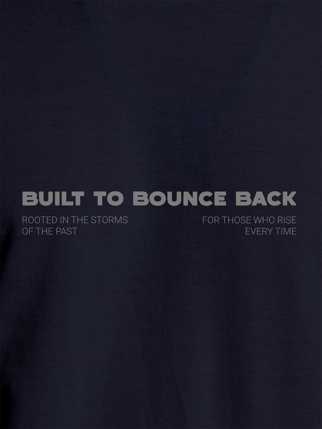 Close up of 'Built To Bounce Back' design on Men's Navy Blue Round Neck T-shirt, highlighting intricate details and vibrant print.
