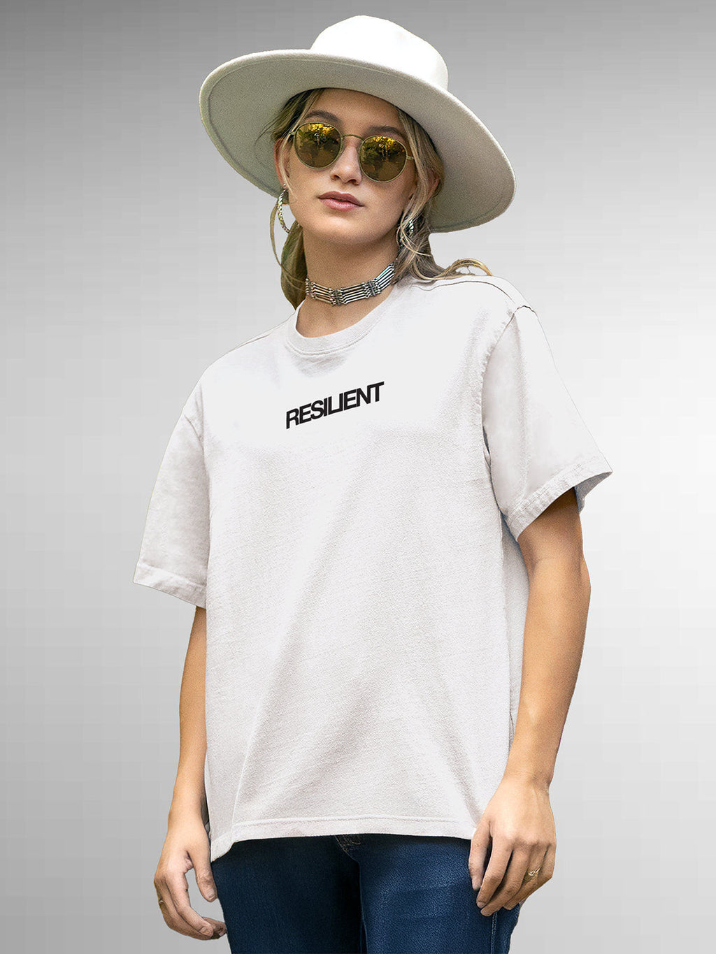 Model wearing Women's White Round Neck T-shirt with 'Resilient' design, offering effortless style and premium comfort