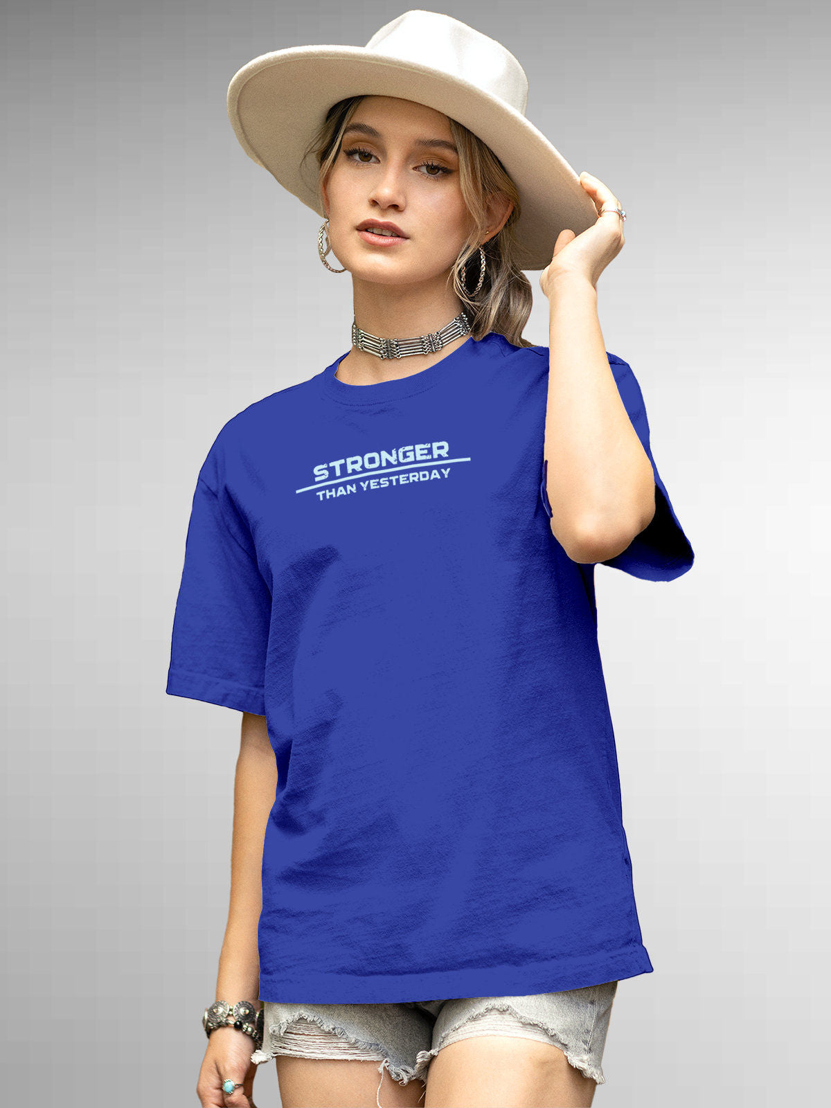 Model wearing Women's Blue Round Neck T-shirt with 'Stronger Than Yesterday' design, offering effortless style and premium comfort