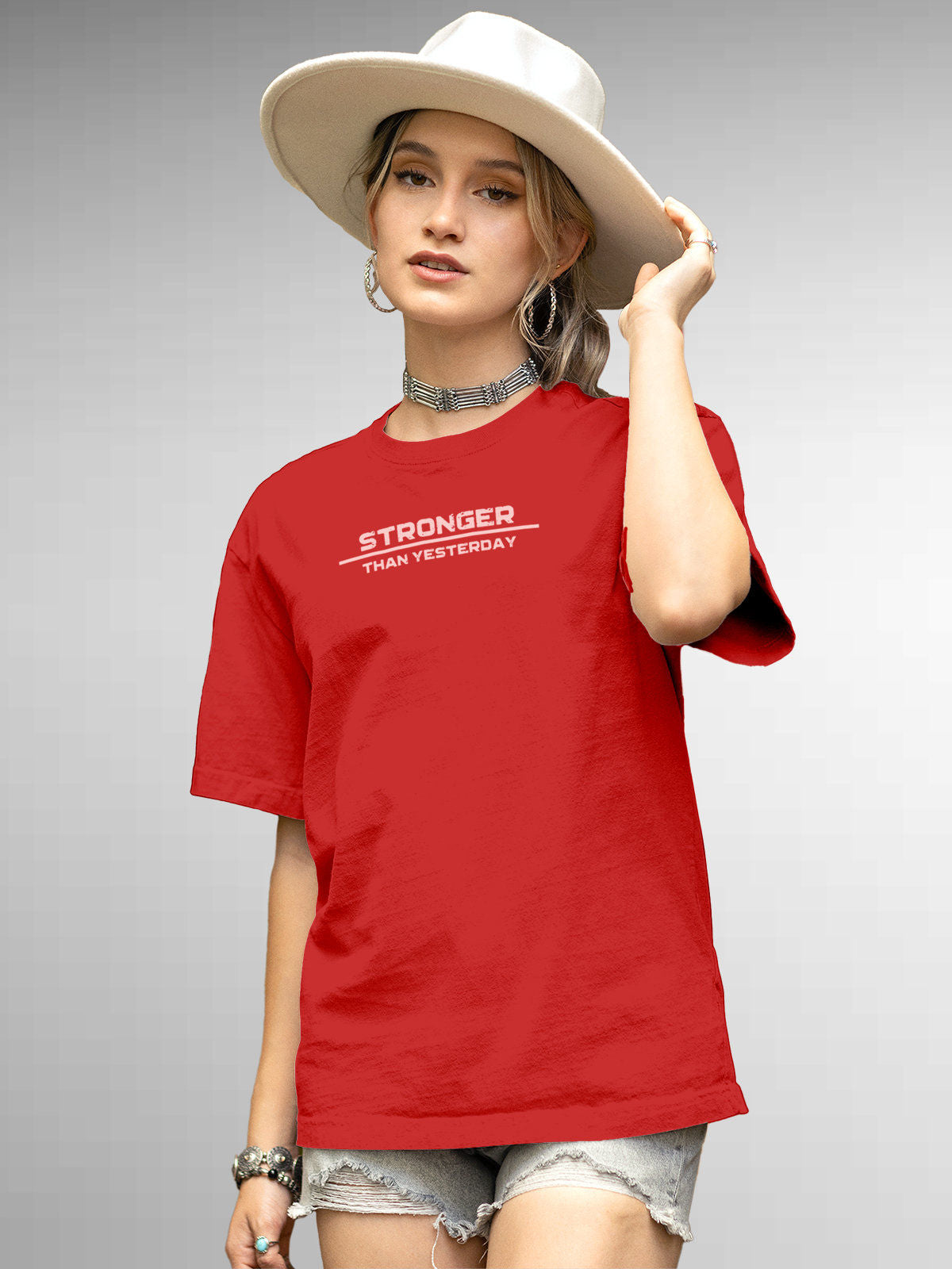Model wearing Women's Red Round Neck T-shirt with 'Stronger Than Yesterday' design, offering effortless style and premium comfort
