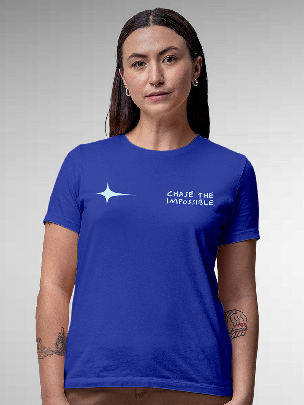 Model wearing Women's Blue Round Neck T-shirt with 'Chase The Impossible' design, offering effortless style and premium comfort