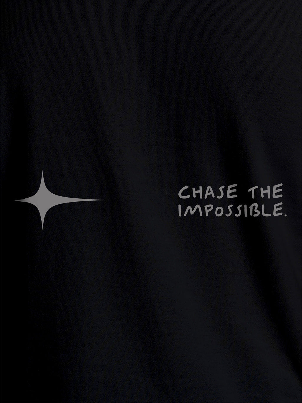 Close up of 'Chase The Impossible' design on Men's Black Round Neck T-shirt, highlighting intricate details and vibrant print.